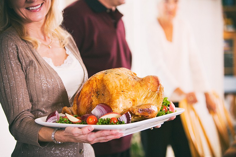 Thanksgiving: Woman Holding Platter With Roast Turkey And Garnis